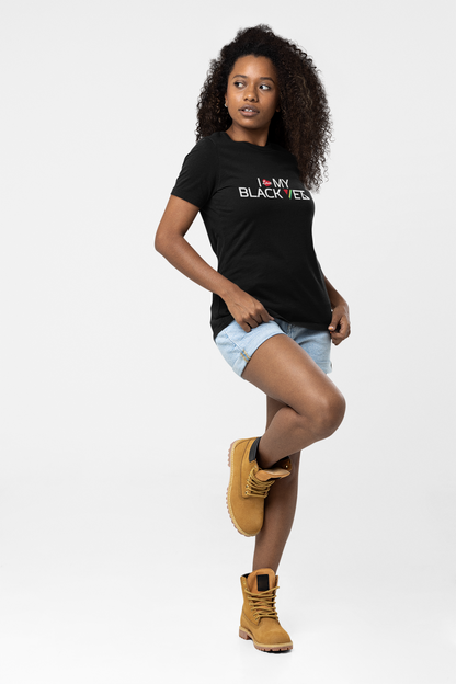 Black woman with Black curly hair Black tshirt with 'I Love My Black Vet' jean shorts and boots